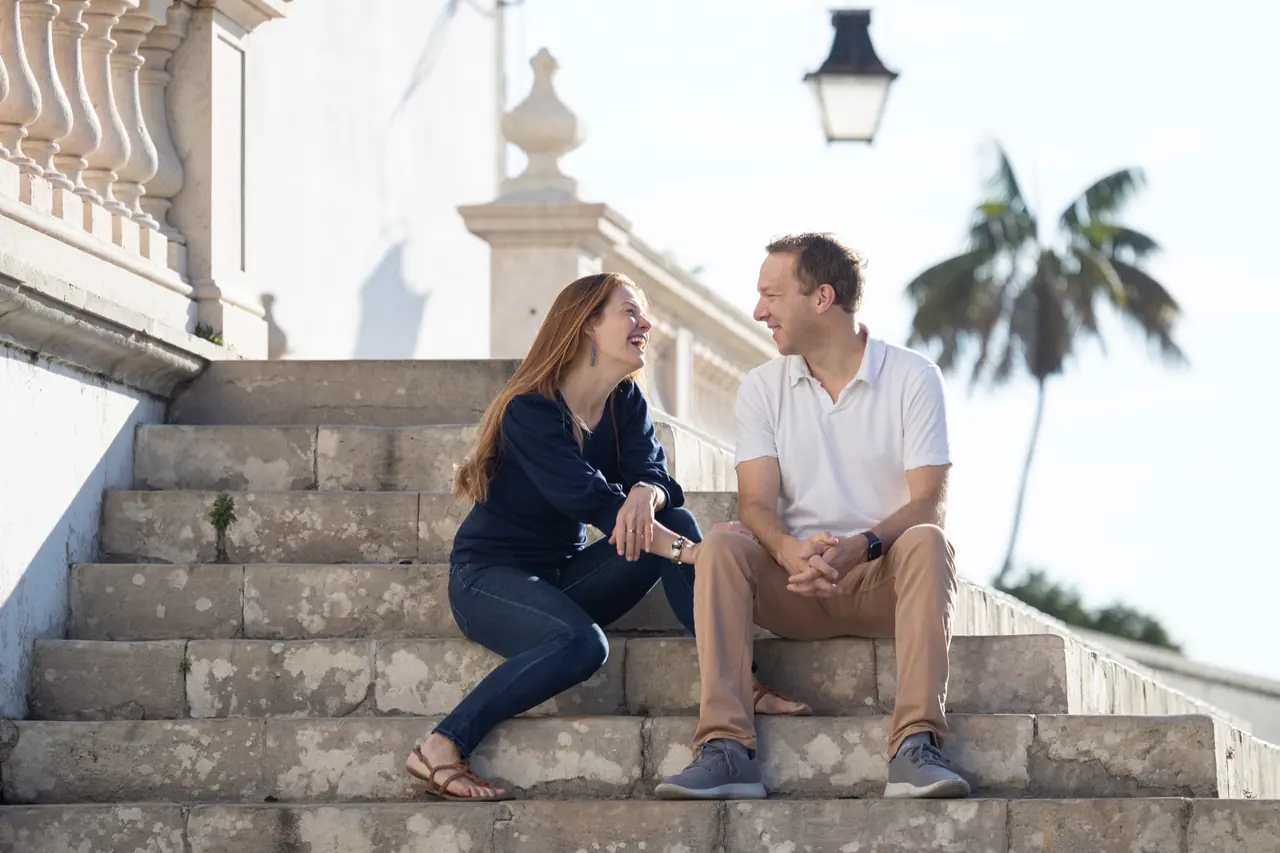 Danielle and Rich laughing together on steps