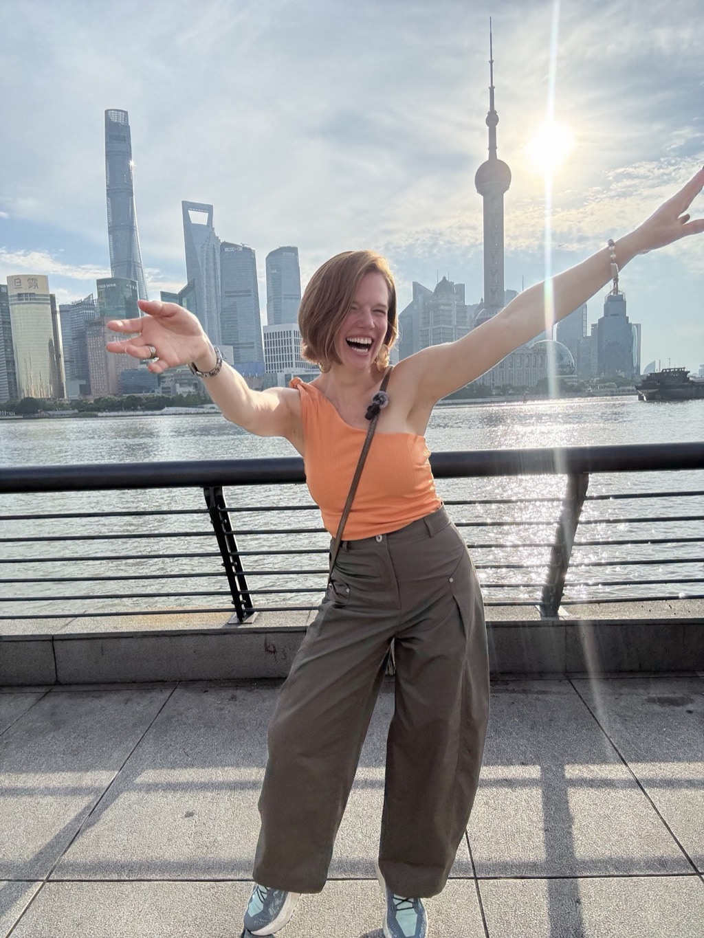 Danielle on the Bund with the Pudong skyline behind her.